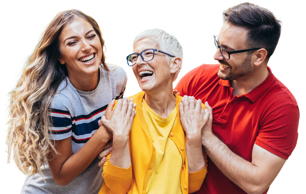 A white-haired woman in yellow stands between a younger man and woman, all are laughing.