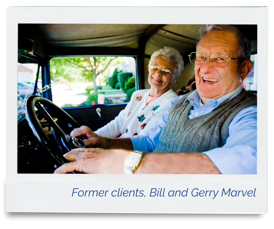 A photo of former clients, Bill and Gerry Marvel, smiling, in their antique car.